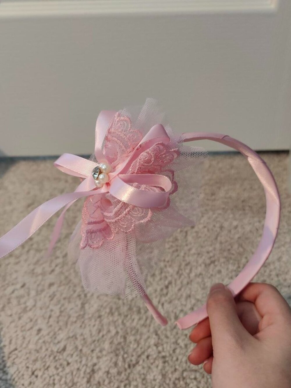 Pink lace headband with bow and pearl detail